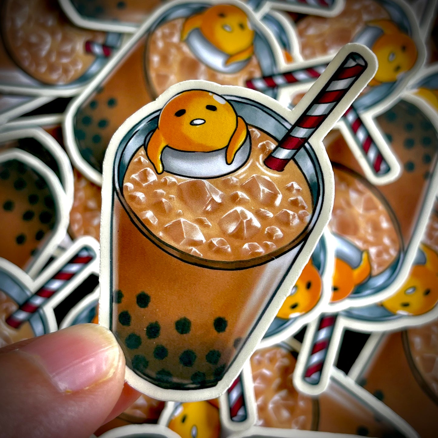 Gudetama the lazy egg lounges in a tall glass of iced boba tea