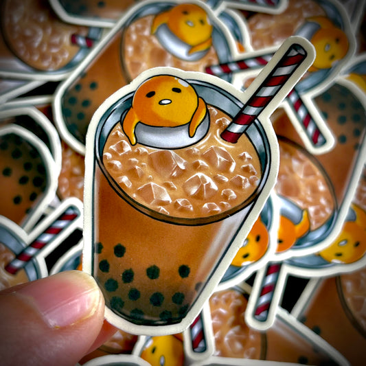 Gudetama the lazy egg lounges in a tall glass of iced boba tea